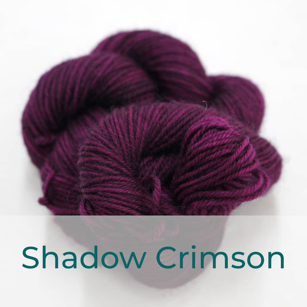 BFL 4 Ply mini skein in Shadow Crimson colourway. It is dark plum / purple.