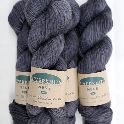 A pile of skeins of Nene DK in charcoal grey
