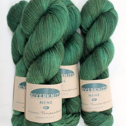 A pile of skeins of Nene DK in forest green