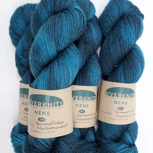 A pile of skeins of Nene DK in deep turquoise teal