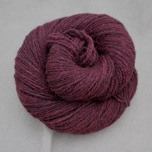 A skein of Severn 4 Ply in a deep wine red colour