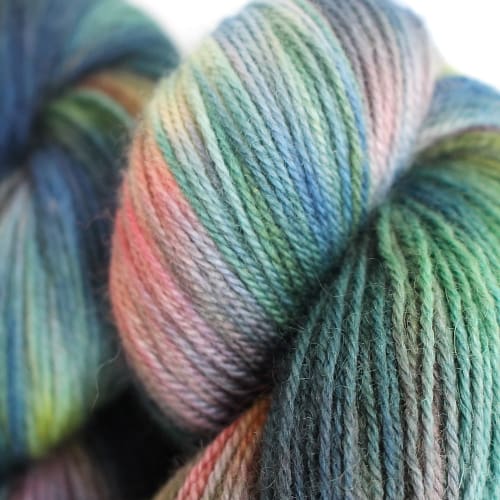 Skeins dyed in variegated soft blues, greens, and pink