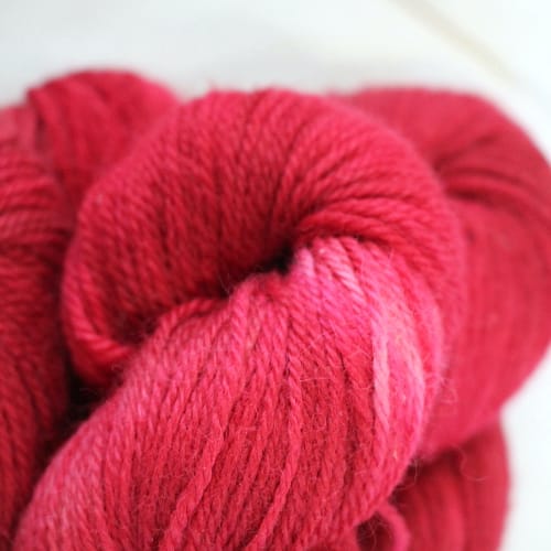 Close up of bright pinky-red yarn