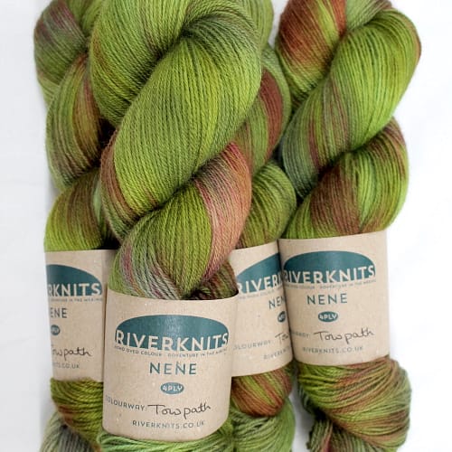 Skeins dyed in variegated greens with hints of copper and red